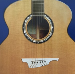 A brown six string cutaway design of a guitar