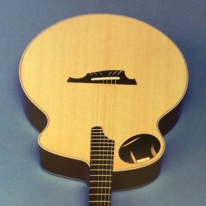 Bass side upper bout oval soundhole guitar design