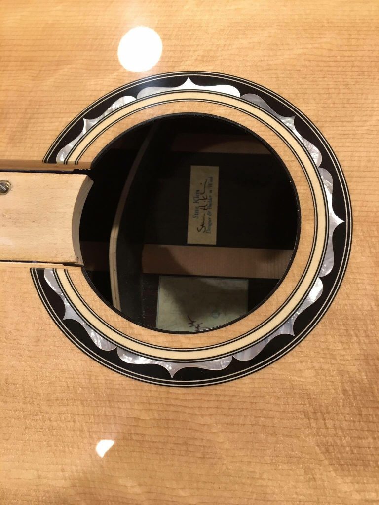 Acoustic guitar soundhole with decorative rosette.
