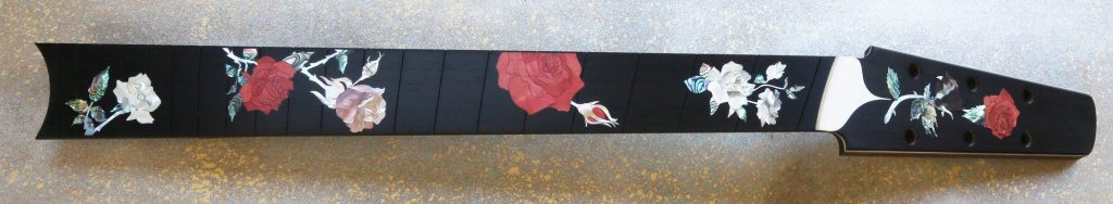 Black belt with colorful floral embroidery.
