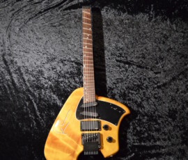 Unique electric guitar on textured background.