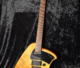 Electric guitar on black textured background.