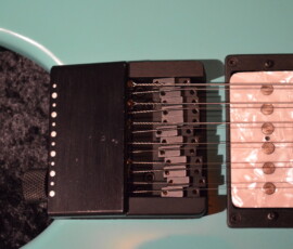 Electric guitar bridge and pickup close-up.