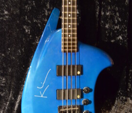 Blue electric bass guitar with unique shape.
