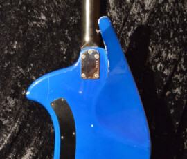 Blue electric guitar on textured background.