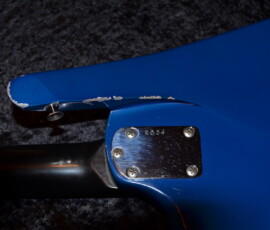 Blue electric guitar with chipped paint.