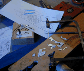 Jewelry making tools and design sketches.