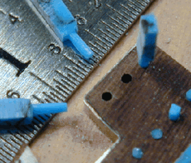 Close-up of ruler and small model parts.