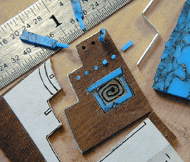Inlay design process with ruler and materials.