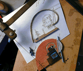 Scroll saw cutting intricate spiral design.