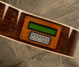 Guitar body with digital tuner display.