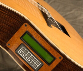 Close-up of guitar side control panel and strings