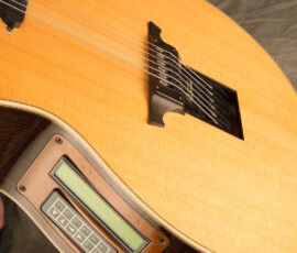 Acoustic guitar with built-in electronic display.