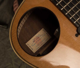 Guitar soundhole close-up with handwritten label