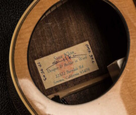 Guitar label inside soundhole with designer info.