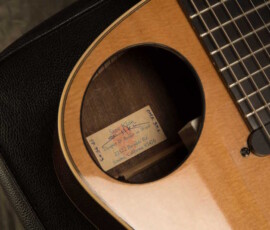 Acoustic guitar with visible interior label.