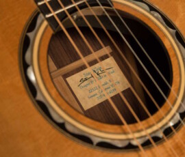 Acoustic guitar soundhole with maker's label.