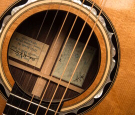 Guitar soundhole showing internal label and strings