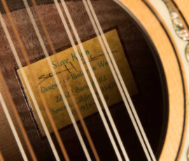 Guitar label inside soundhole with strings visible.