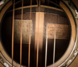 Acoustic guitar soundhole with internal labels.