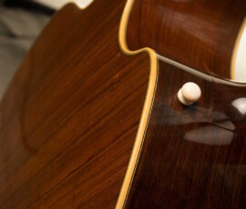 Wooden guitar back with glossy finish.