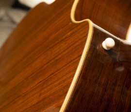 Glossy wooden guitar back with strap button