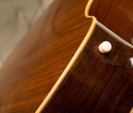 Close-up of wooden guitar body detail.