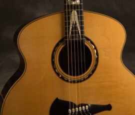 Acoustic guitar with intricate design details.