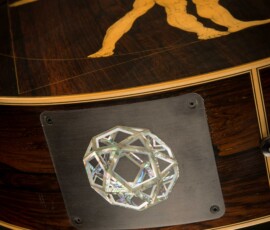 Wooden surface with geometric crystal design.