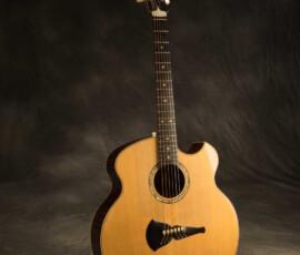 Classical-style acoustic guitar with ornate bridge