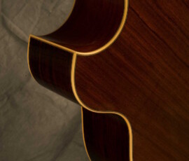 Curved guitar body back with decorative binding