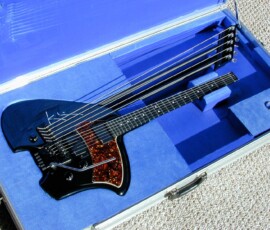 Black electric guitar in blue lined case