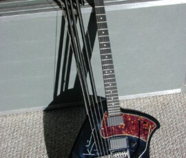 Black multi-neck electric guitar on case