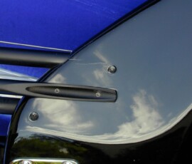 Close-up of sleek black car detail.