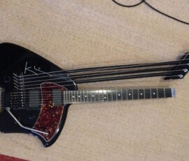 Unique black guitar with three necks.