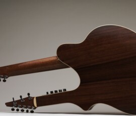 Double-neck acoustic guitar on display.