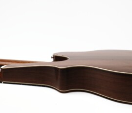 Double-neck guitar lying on white background.